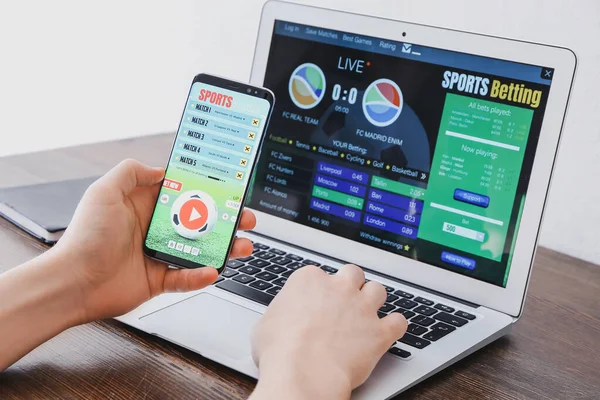Man placing sports bet at home